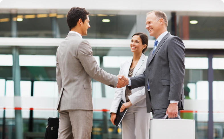 Smiling professionals meeting in modern setting
