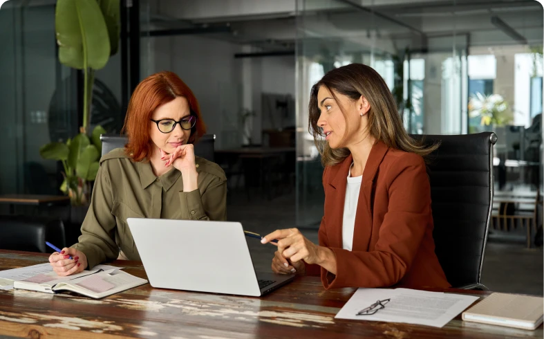 Professionals collaborating over a computer.