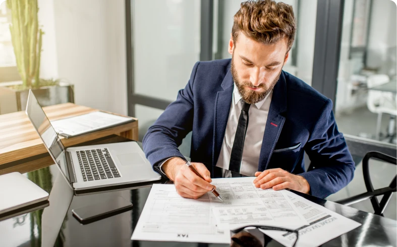 Businessman reviewing documents at desk