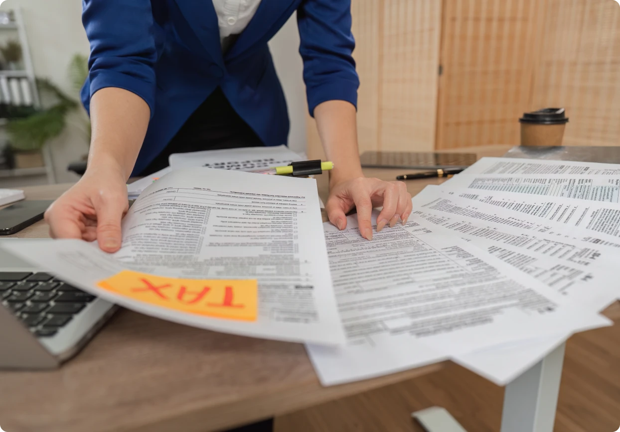 Sorting tax documents on a desk